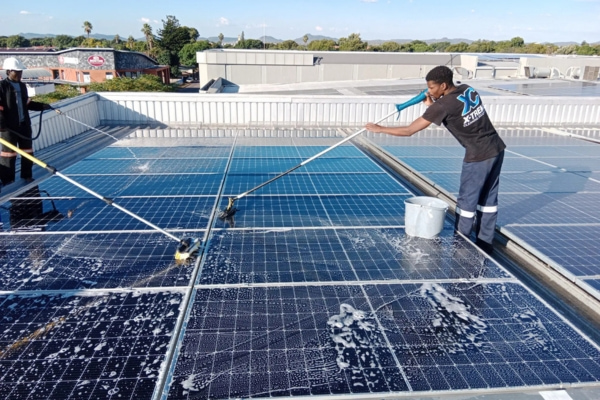 Cleaning solar panels on roof